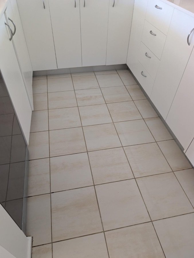 Clean kitchen floor tiles and grout lines after professional tile cleaning