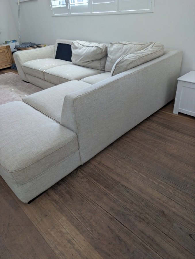 Cream fabric corner lounge in a living room after professional upholstery cleaning