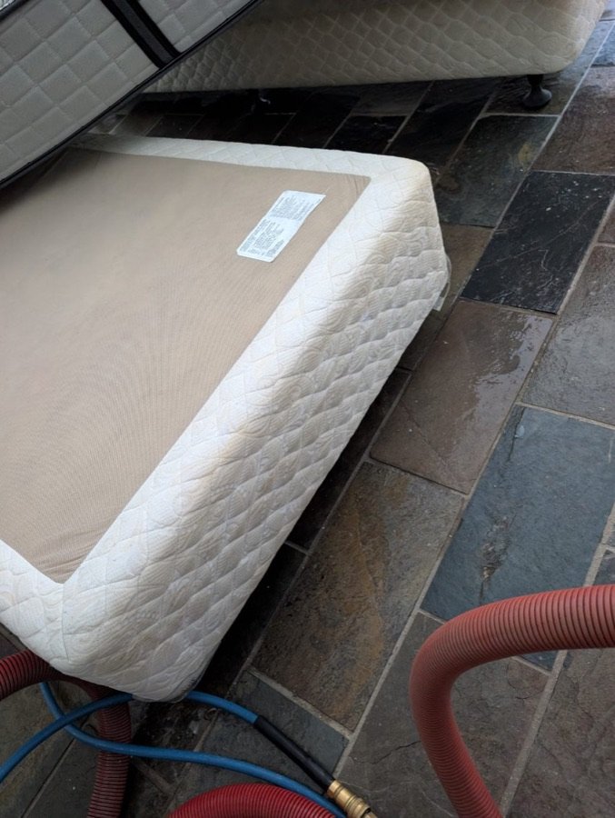 After: white quilted mattress base on slate tiles looking clean and evenly coloured after mattress cleaning